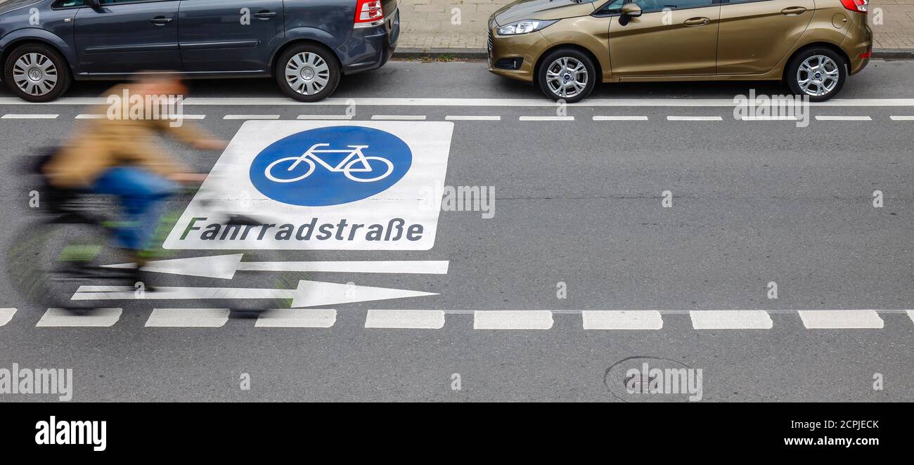Essen, North Rhine-Westphalia, Germany - Cyclists ride on a new bicycle street with freshly applied pictograms, here the Kahrstrasse in the district Stock Photo