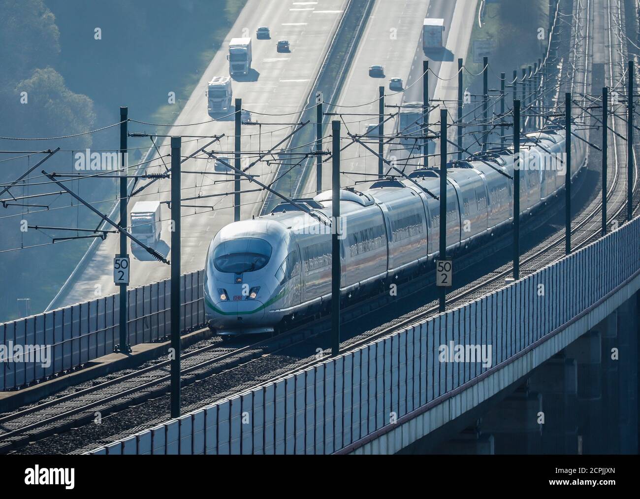 ICE train of the Deutsche Bahn AG runs on the high-speed line Cologne-Frankfurt, in the back cars and trucks drive on the A3 motorway, Neustadt Wied, Stock Photo