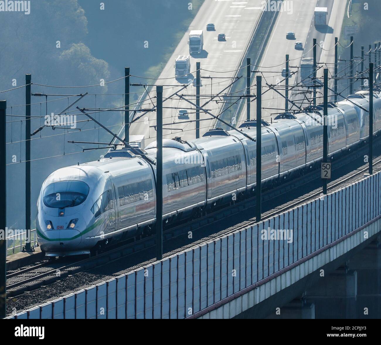 ICE train of the Deutsche Bahn AG runs on the high-speed line Cologne-Frankfurt, in the back cars and trucks drive on the A3 motorway, Neustadt Wied, Stock Photo