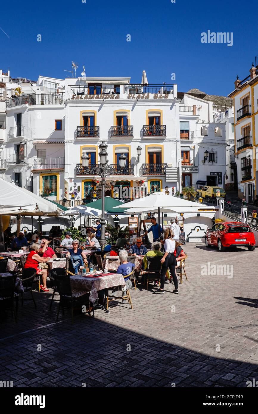 Restaurants in the village square in the white mountain village of Competa, Andalusia, Spain Stock Photo