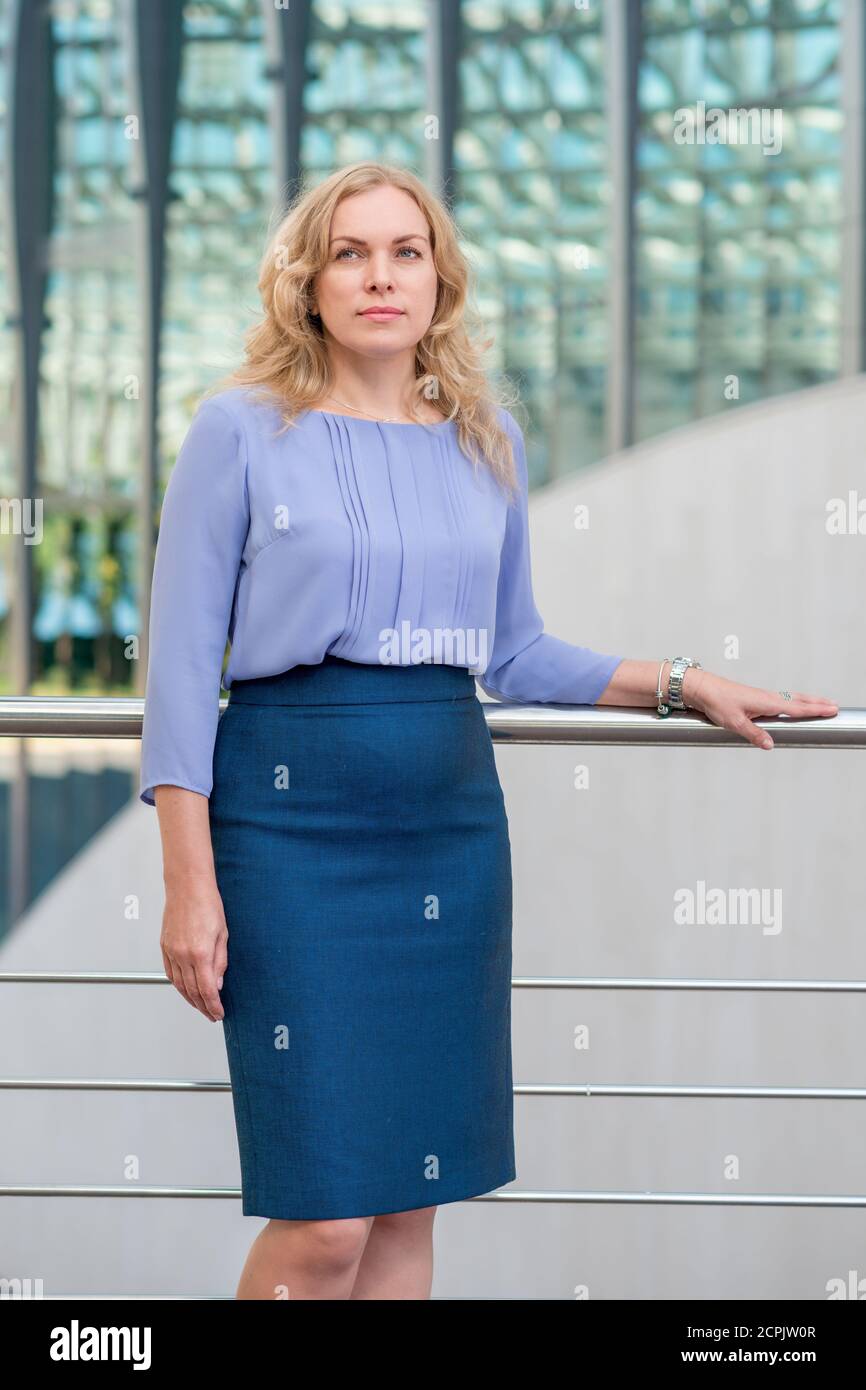 Portrait of a blonde woman wearing a skirt and blouse Stock Photo