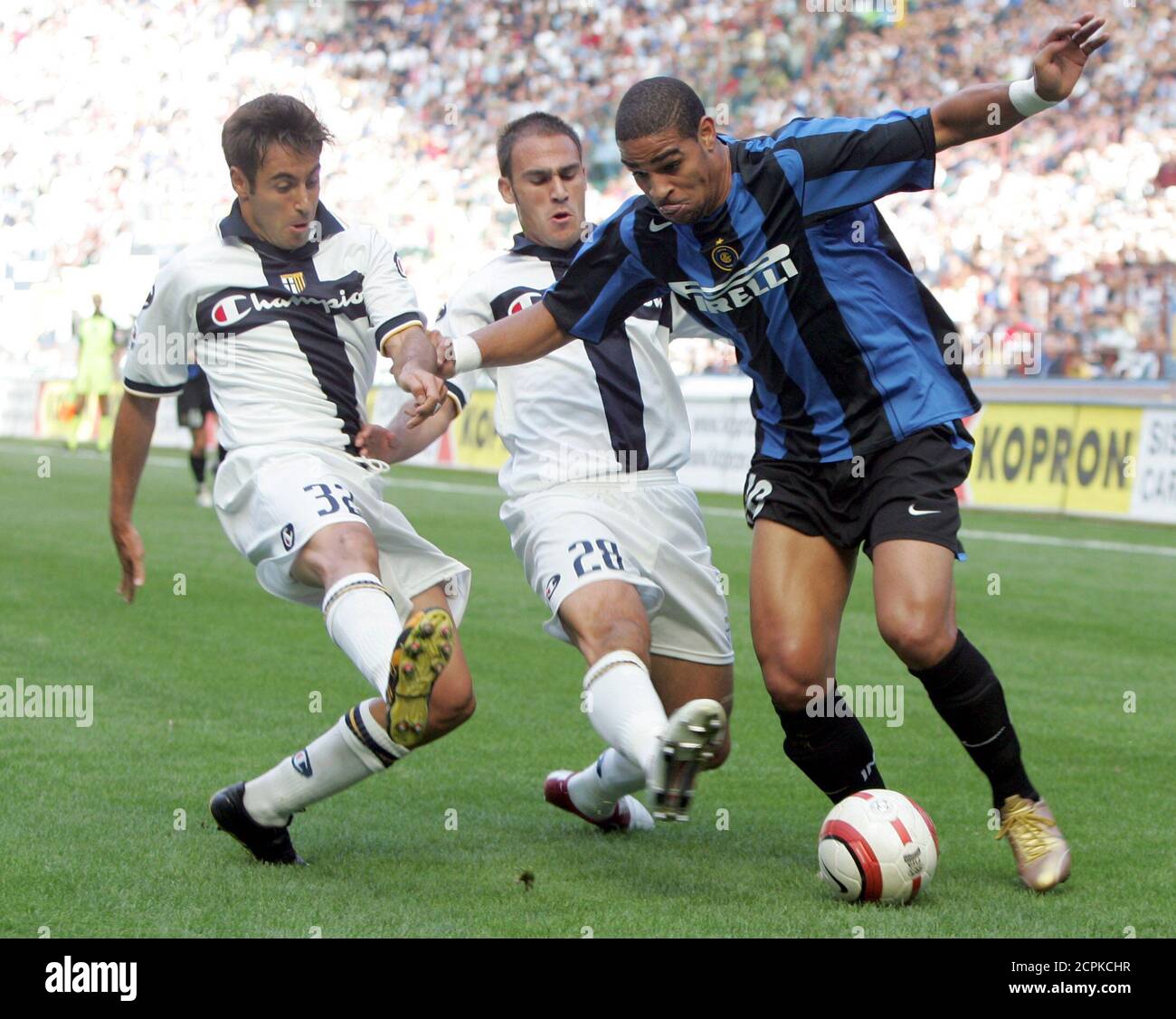 Inter Milan Adriano (R) challenges Marco Marchionni (L) and Paolo Cannavaro of Parma during their serie A match at the San Siro stadium in Milan, northern Italy September 26, 2004. Inter Milan vs Parma 2-2 draw. REUTERS/Stefano Rellandini  SR/ACM Stock Photo