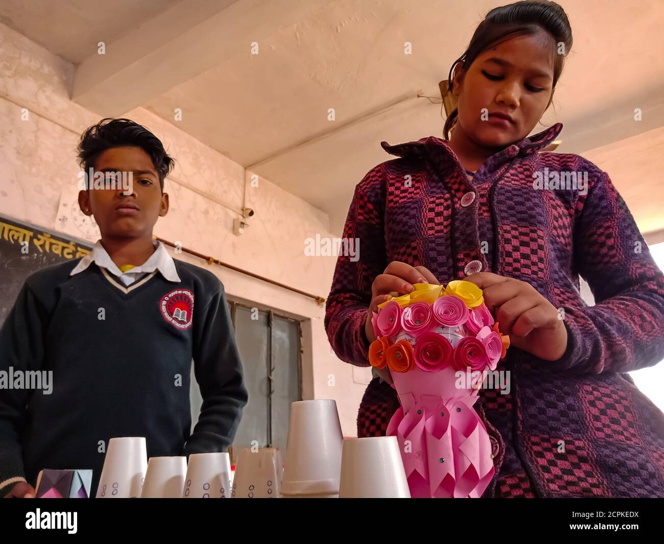 DISTRICT KATNI, INDIA - JANUARY 21, 2020: Indian government school students creating decorative model for exhibition at classroom. Stock Photo