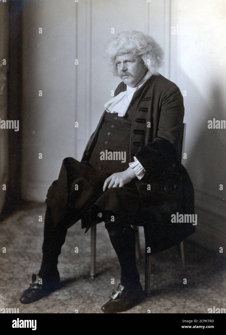 G K Chesterton as Dr Samuel Johnson at the Branksome Tower Hotel, Bournemouth in 1930. Taken from an original photograph by N D Larkin for the London photographers Larkin Brothers Stock Photo