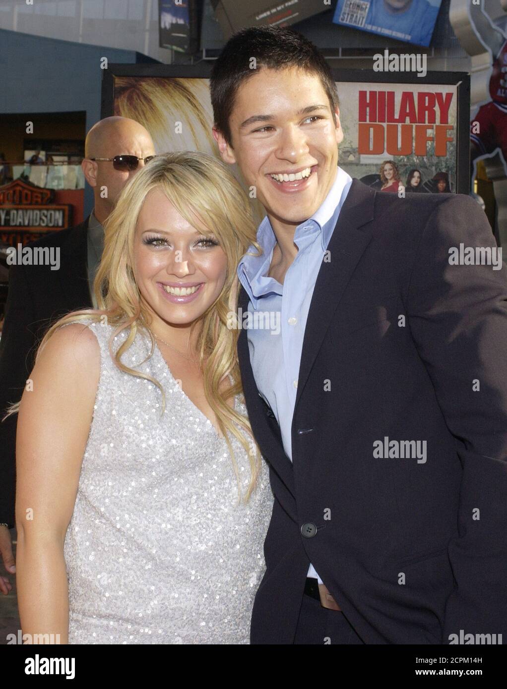 Hilary Duff (L) and Oliver James, cast members in the romantic drama motion  picture "Raise Your Voice," pose during the premiere of the film in Los  Angeles, California October 3, 2004. REUTERS/Jim