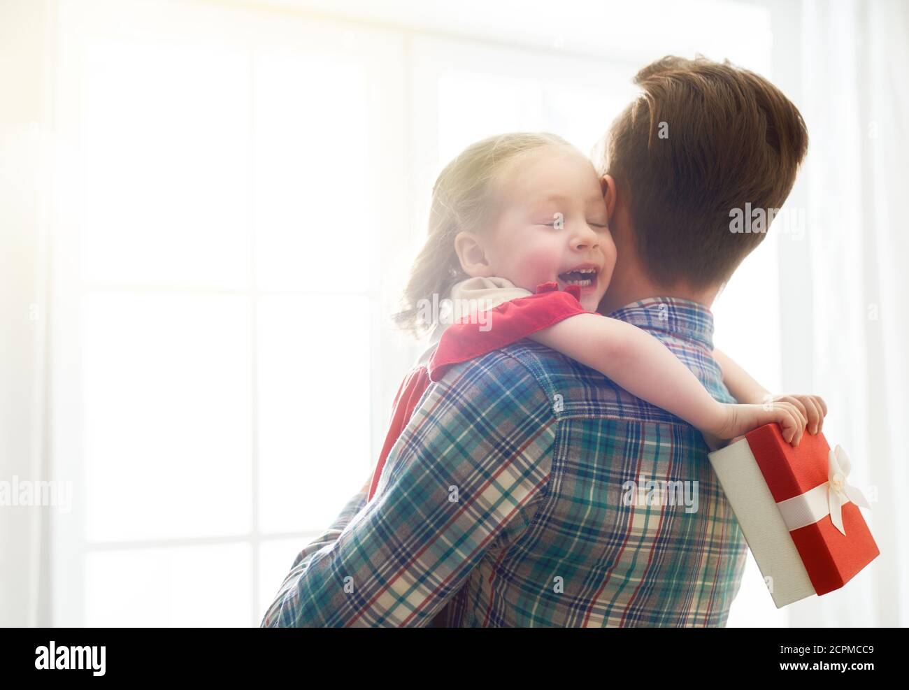 Happy father's day! Child daughter congratulating dad and giving him a ...