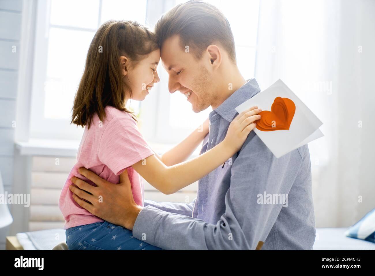 Happy father's day! Child daughter congratulating dad and giving him ...