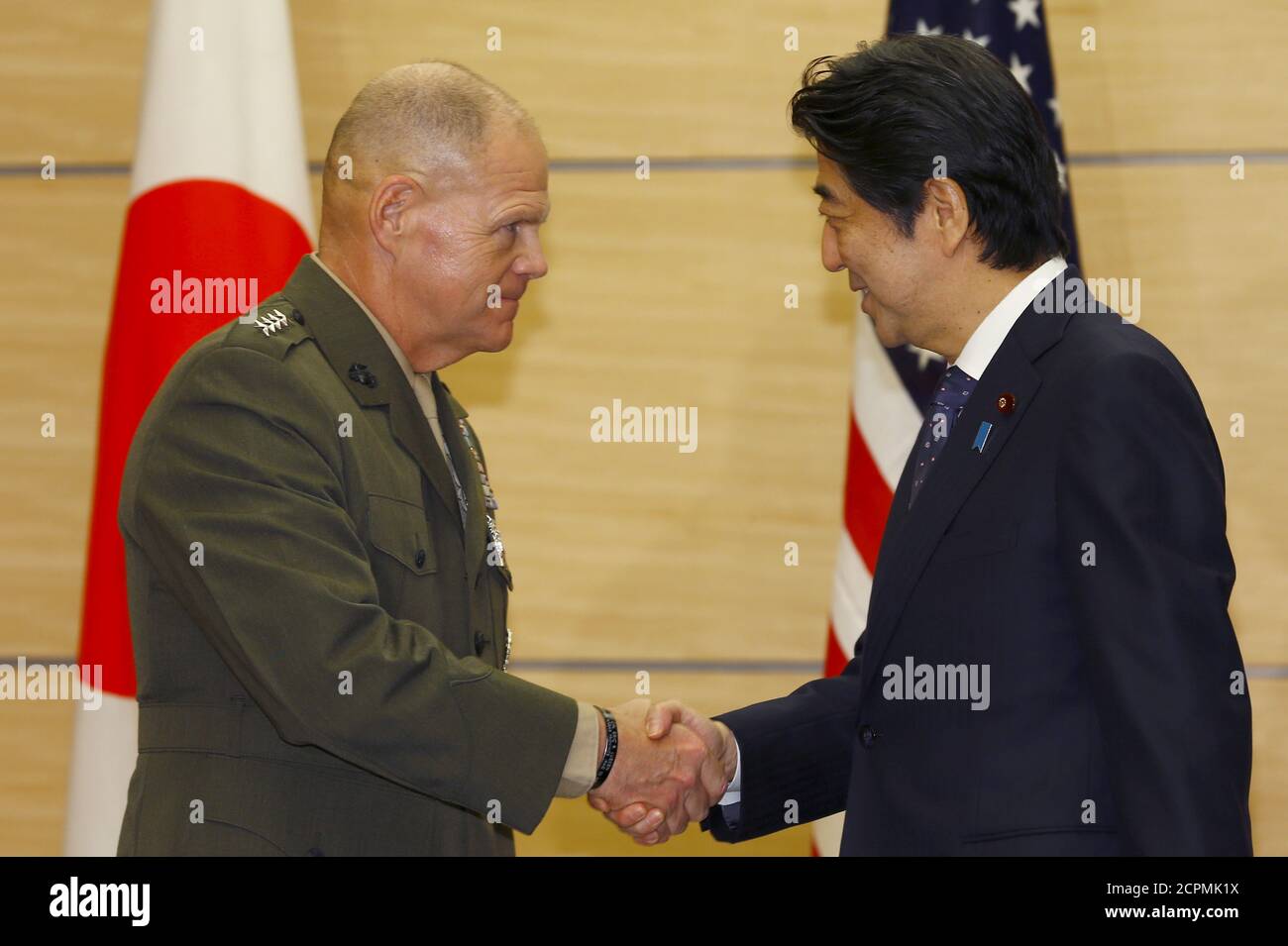 Gen. Robert B. Neller, Commandant of the U.S. Marine Corps, is greeted by Japanese Prime Minister Shinzo Abe prior to a meeting at Abe's official residence in Tokyo, November 25, 2015. REUTERS/Shizuo Kambayashi/Pool Stock Photo