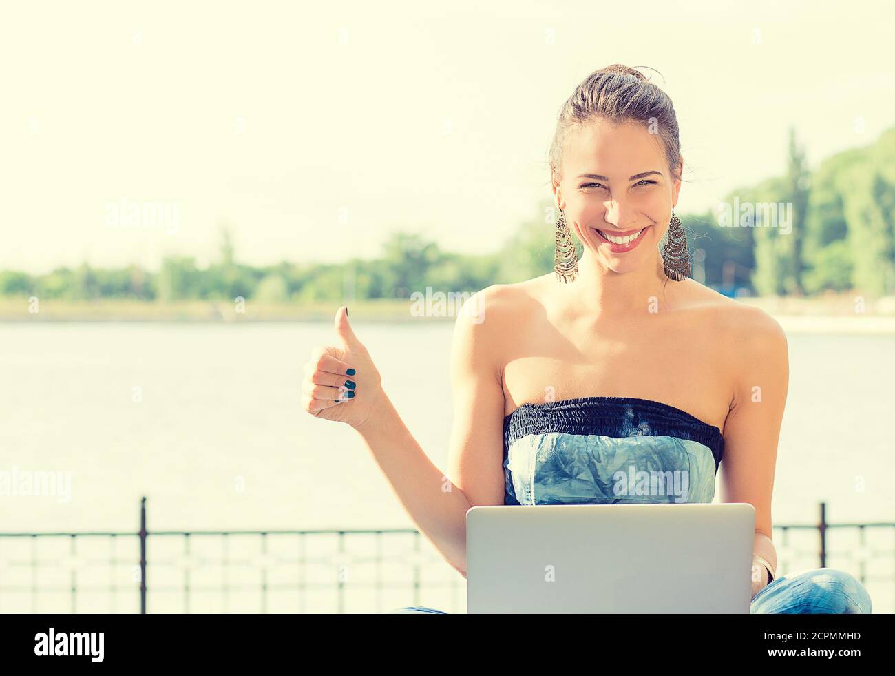 Girl sitting knees up smiling hi-res stock photography and images - Alamy