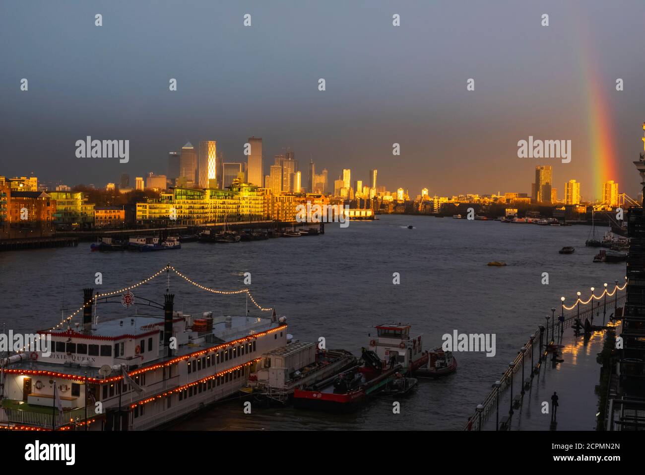England, London, Docklands, River Thames and Canary Wharf, Skyline and Rainbow Stock Photo
