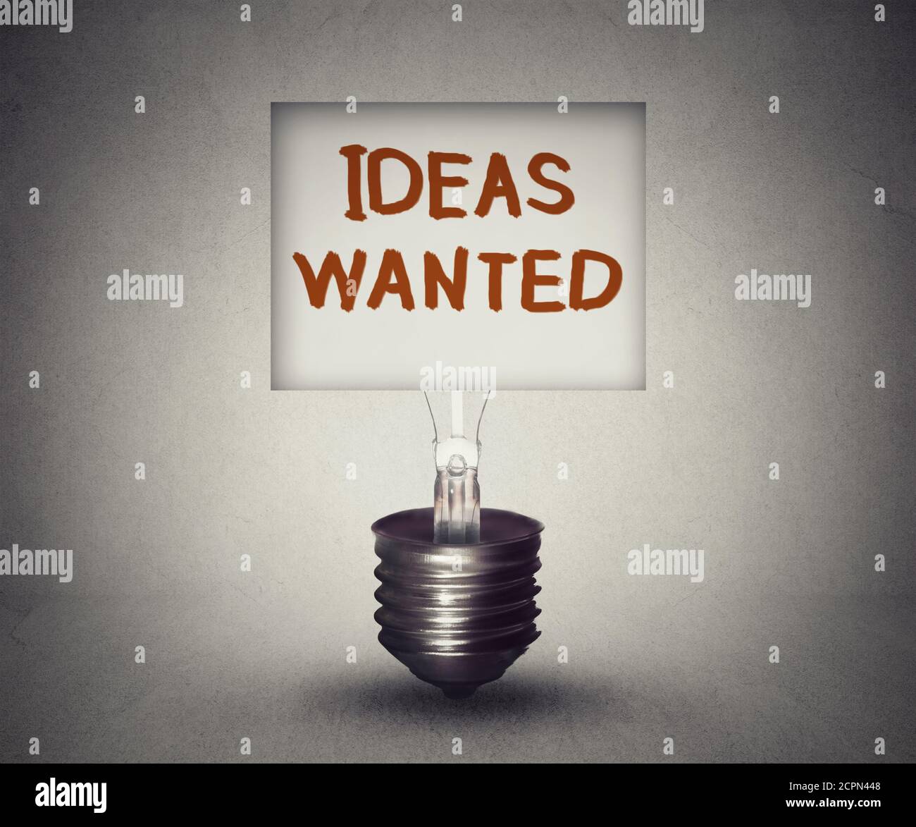Ideas wanted concept and talent search symbol sign with classified ad symbol in empty lightbulb search for new innovative thoughts icon of business mo Stock Photo