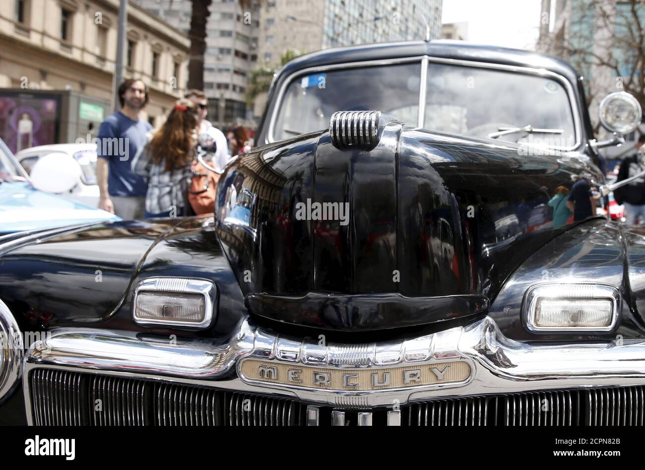 People observe a 1947 Mercury during the 25th edition of the '1000 millas sport e historicos' (1000 miles sports and classic) race in Montevideo, October 28, 2015. The race will cover 1000 miles from 28 to 31 of October.  REUTERS/Andres Stapff Stock Photo