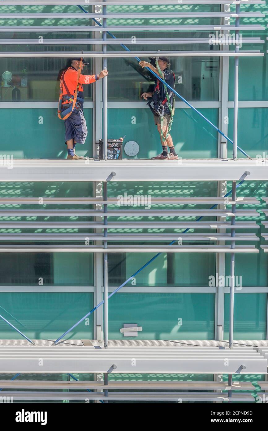 Darwin, Australia March 14th, 2020 Two men working on the outer wall