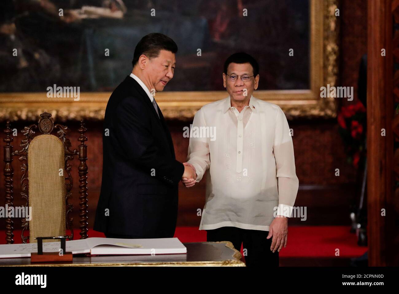 China's President Xi Jinping and Philippine President Rodrigo Duterte shake hands after a book signing at the Malacanang presidential palace in Manila, Philippines, November 20, 2018.  Mark Cristino/Pool via Reuters Stock Photo