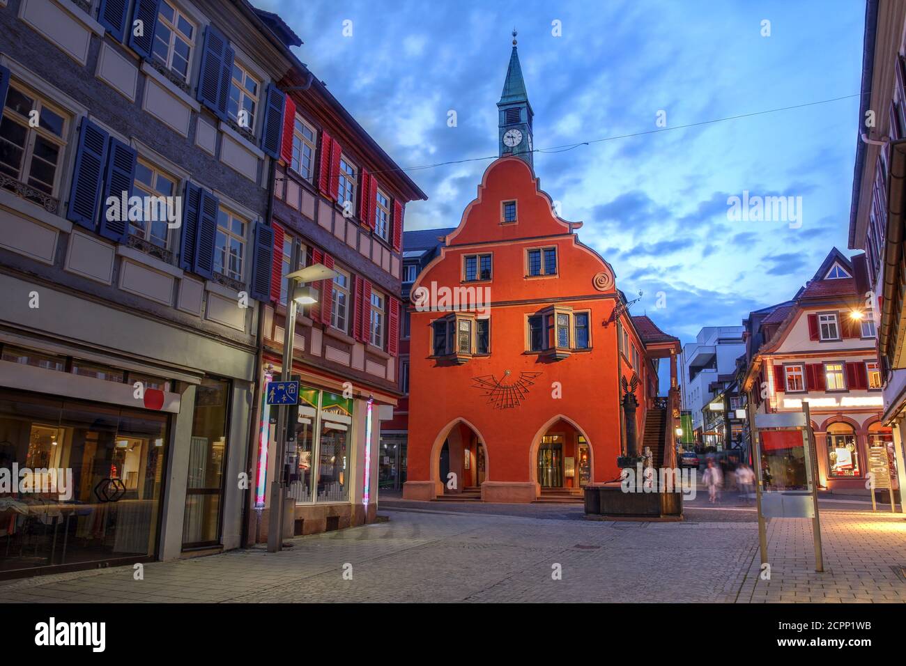 Twilight scene in the small town of Lahr in the Black Forest, Germany (province of Baden Wurttemberg) with focus on the red building of the Town Hall. Stock Photo