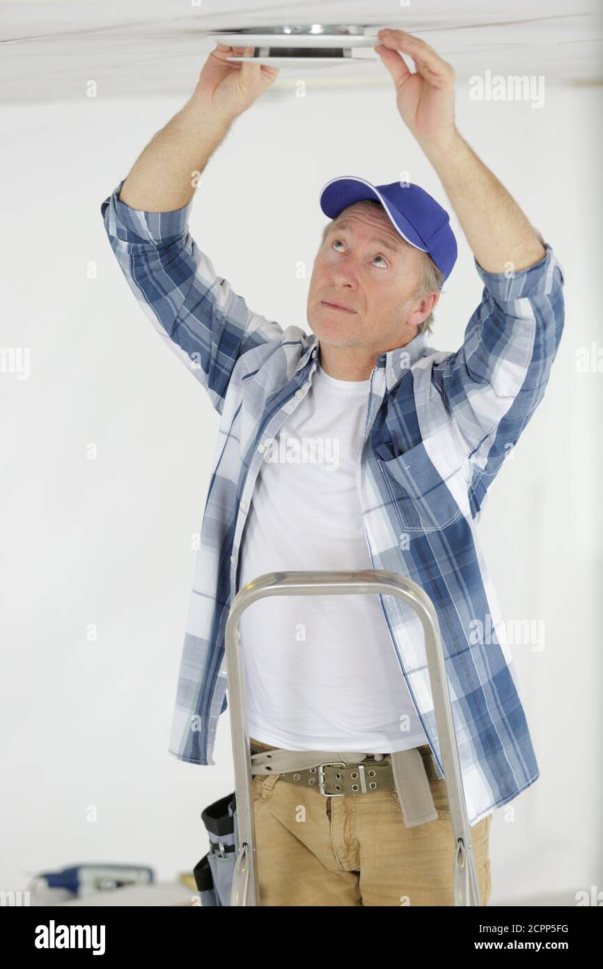 Spotlight Fix Position installing a spotlight in the room Stock Photo - Alamy