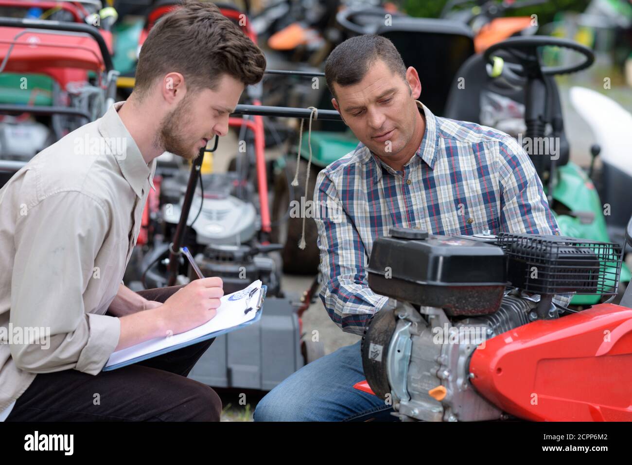 men repair brush cutter engine Stock Photo Alamy