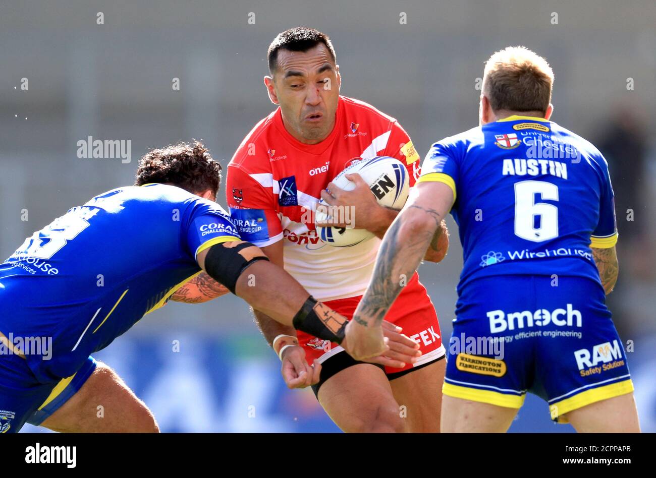 St Helens' Zeb Taia (centre) is tackled by Warrington Wolves' Blake Austin (right) and Ben Murdoch-Masila during the Betfred Super League match at the AJ Bell Stadium, Salford. Stock Photo