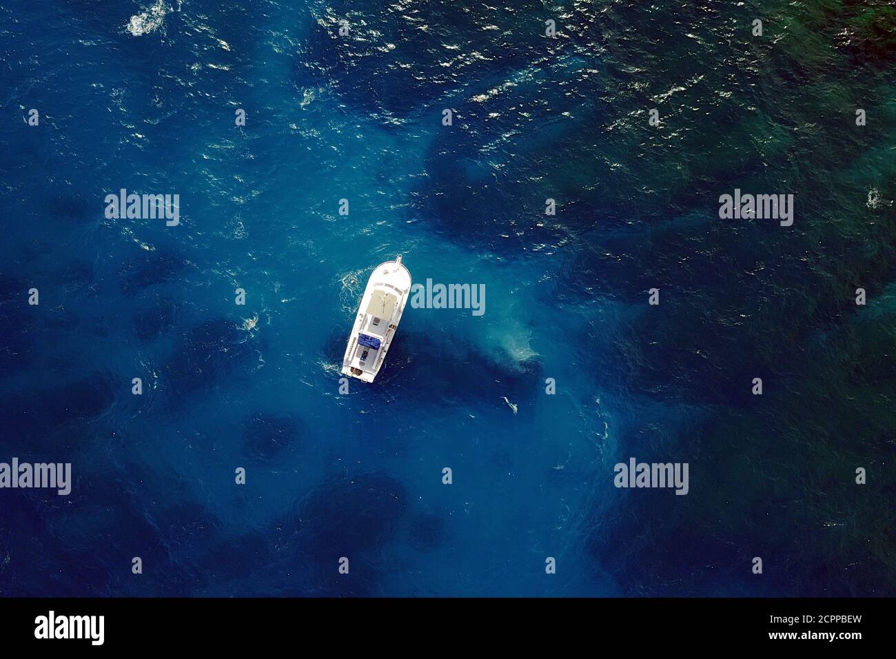 Aerial image of a diving boat above blue clear waters. Location: Ochos Rios, Jamaica, Caribbean Sea. Stock Photo
