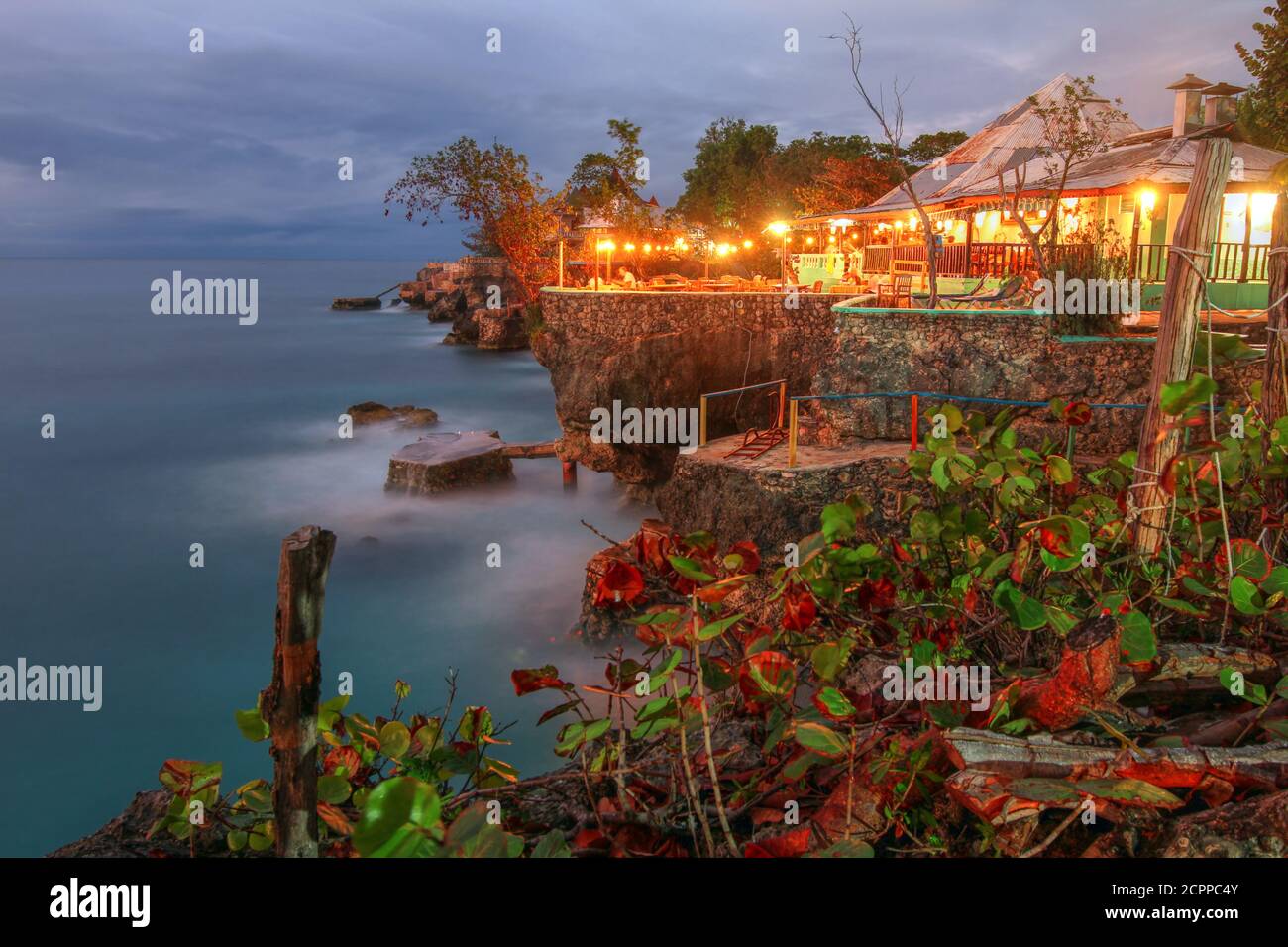 Twilight at 3 Dives point in Negril, Jamaica. The rocky outcrops are very popular for cliff jumping and the location is renown for watching the sunset Stock Photo