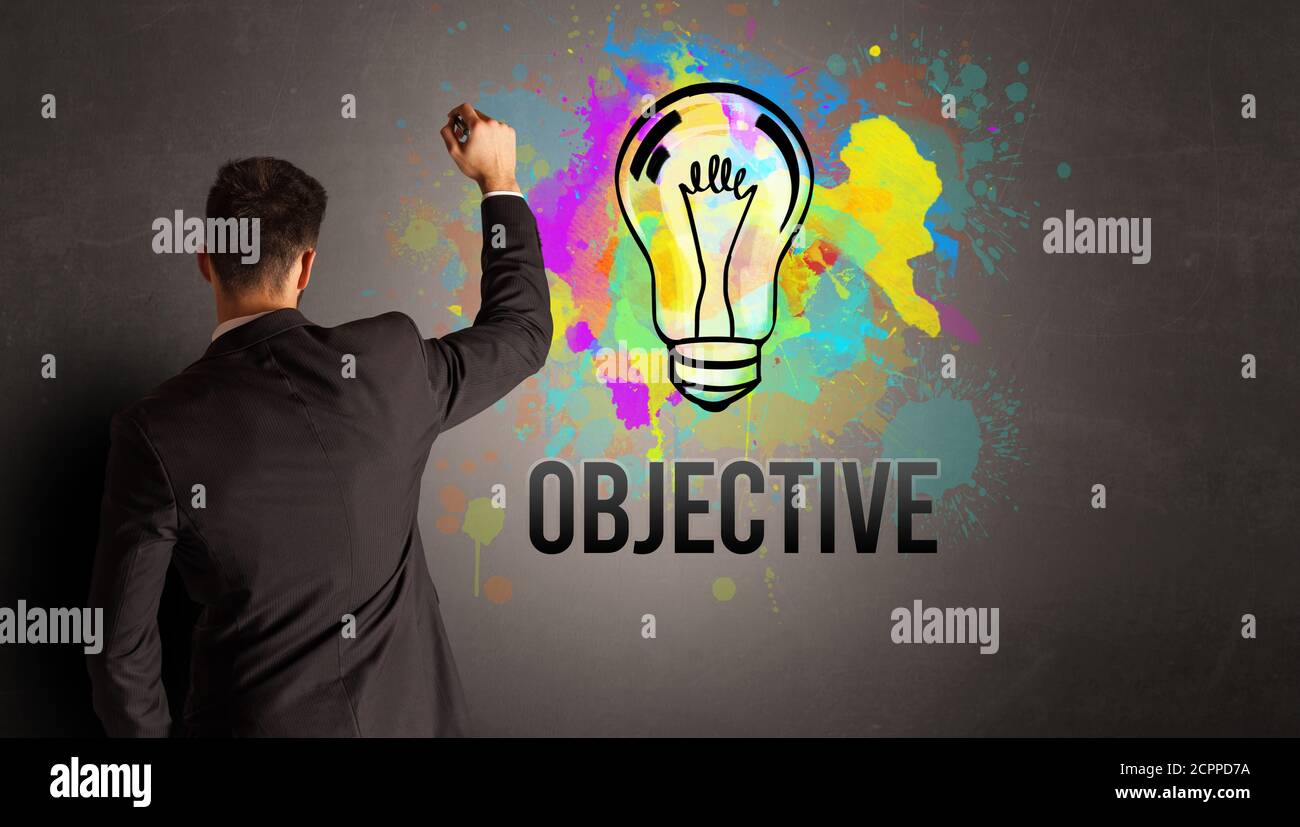 businessman drawing colorful light bulb with OBJECTIVE inscription on ...