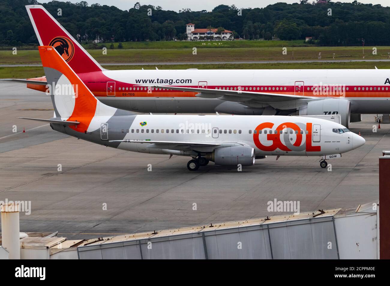 Boeing 737-700 NG of Gol Linhas Aereas approaching to boarding passnegers at terminal 2 of  Guarulhos International Airport. Stock Photo