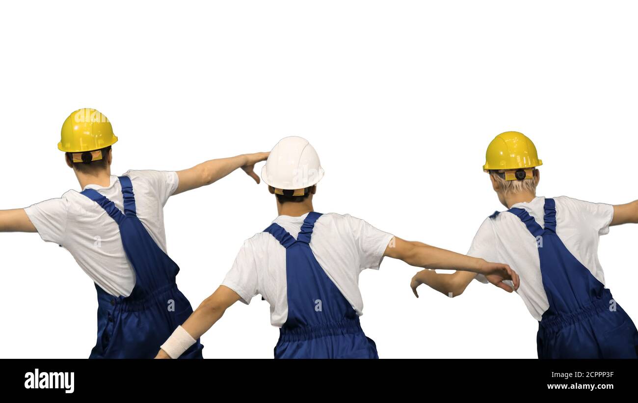 Three male construction workers in hard hats synch dancing with Stock Photo