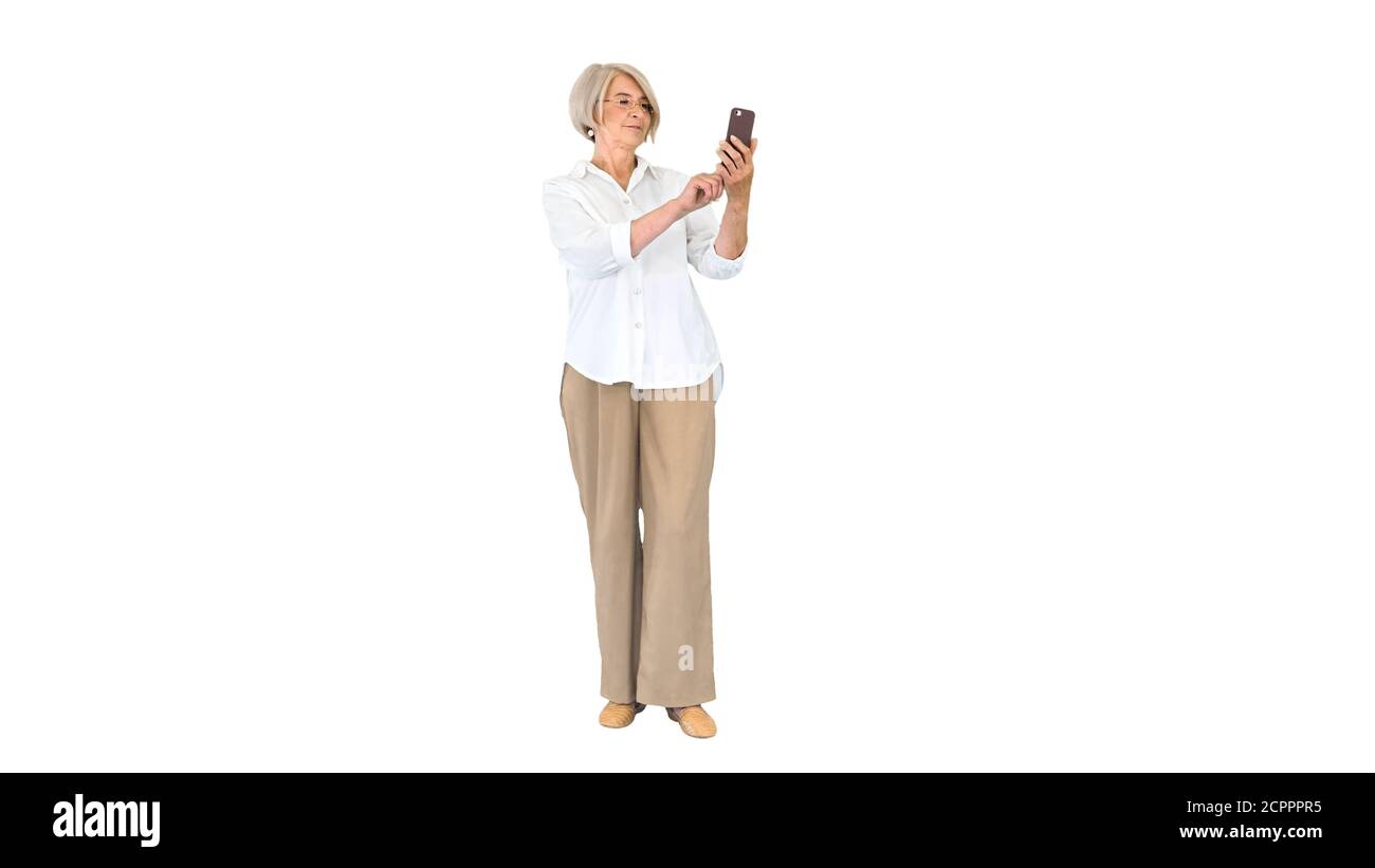 Intelligent grandma taking a selfie on white background. Stock Photo