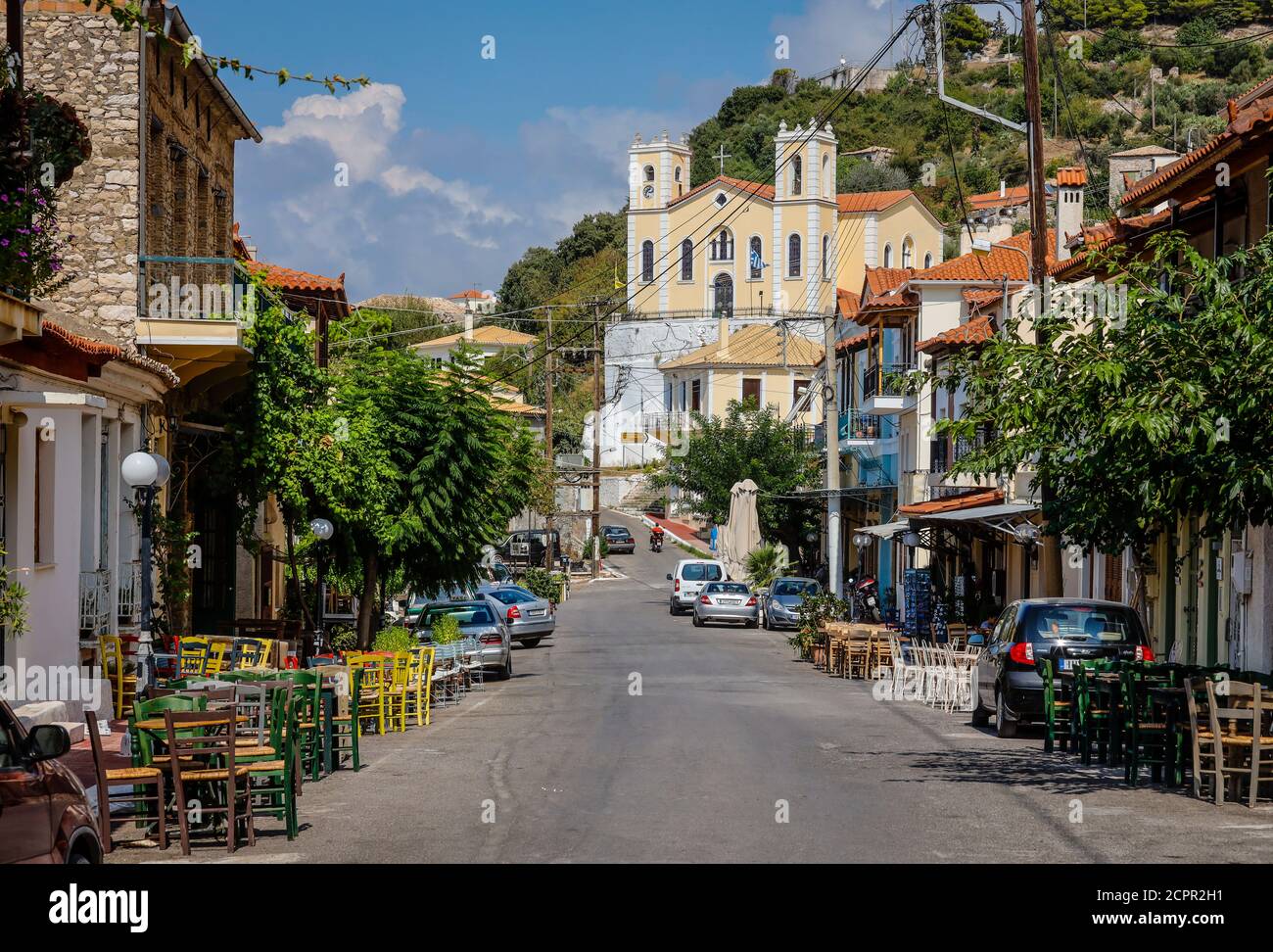 Kyparissia, Messenia, Peloponnese, Greece - City view in the upper town with street cafes and restaurants, view towards the Church of the Holy Trinity Stock Photo