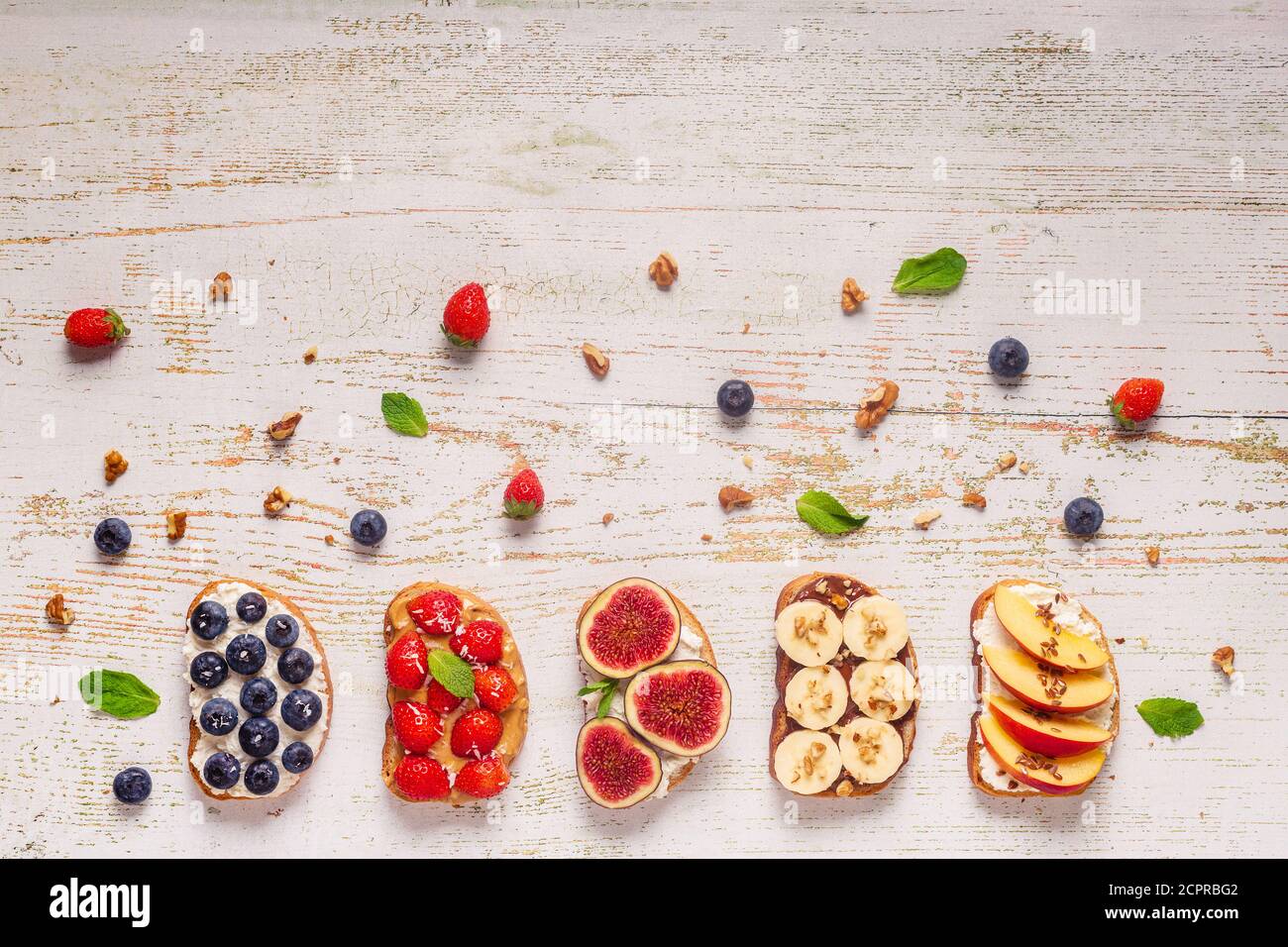 Homemade summer toast with cream cheese, nut butter and fruits and