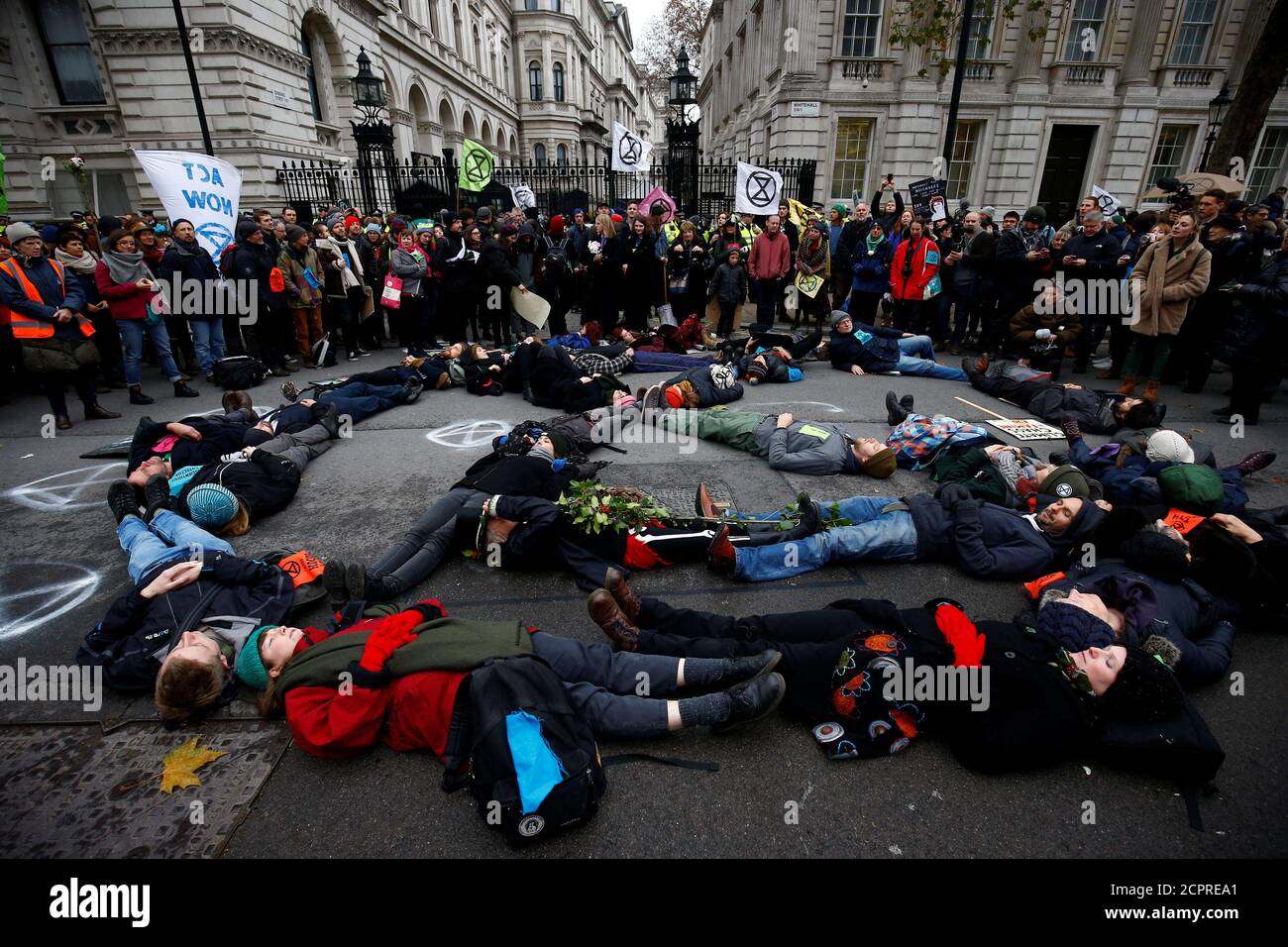 Demonstrators from environment protest groups lay in the road at the entrance to Downing Street, during an Extinction Rebellion protest, central London, Britain November 24, 2018. REUTERS/Henry Nicholls Stock Photo