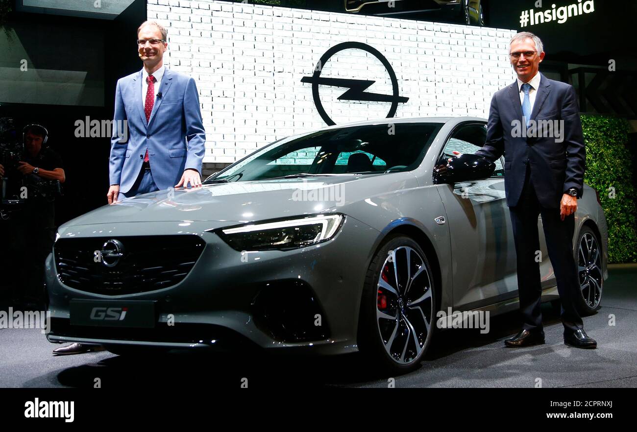 Chairman of the Managing Board of French carmaker PSA Group Carlos Tavares  poses with Michael Lohscheller, CEO of Adam Opel GmbH next to the new Opel  Insignia GSI during the Frankfurt Motor