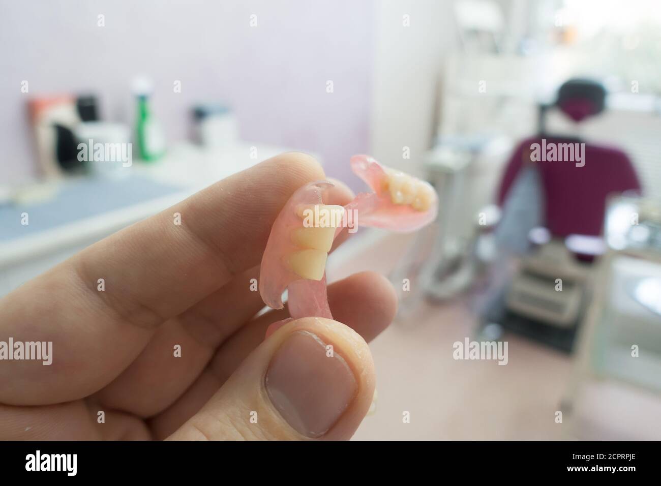 modern nylon dental prosthesis in the hands of a doctor Stock Photo
