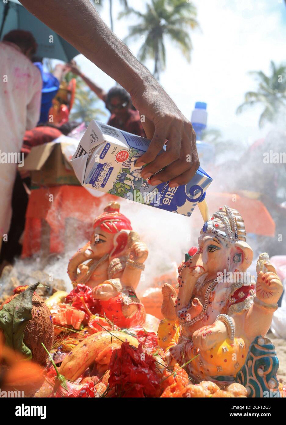 A Hindu devotee pours milk over a murti of elephant god Ganesha during the Ganesh Utsav festival at Manzanilla Beach, Trinidad and Tobago, September 23, 2018. Picture taken September 23, 2018.  REUTERS/Andrea De Silva Stock Photo