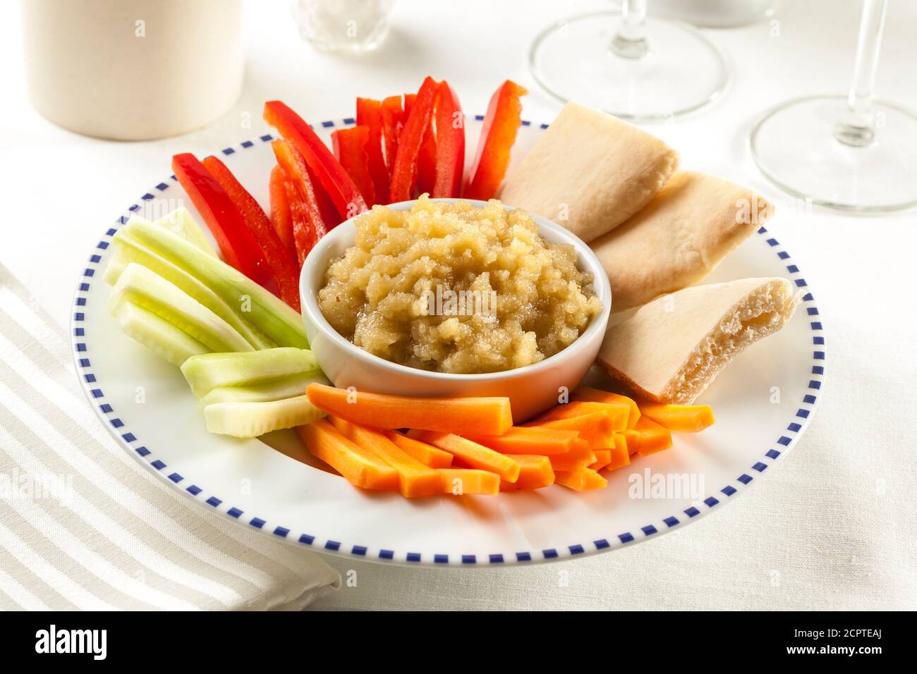 Garlic dip with carrots, cucumber, bell pepper and pita bread. Stock Photo