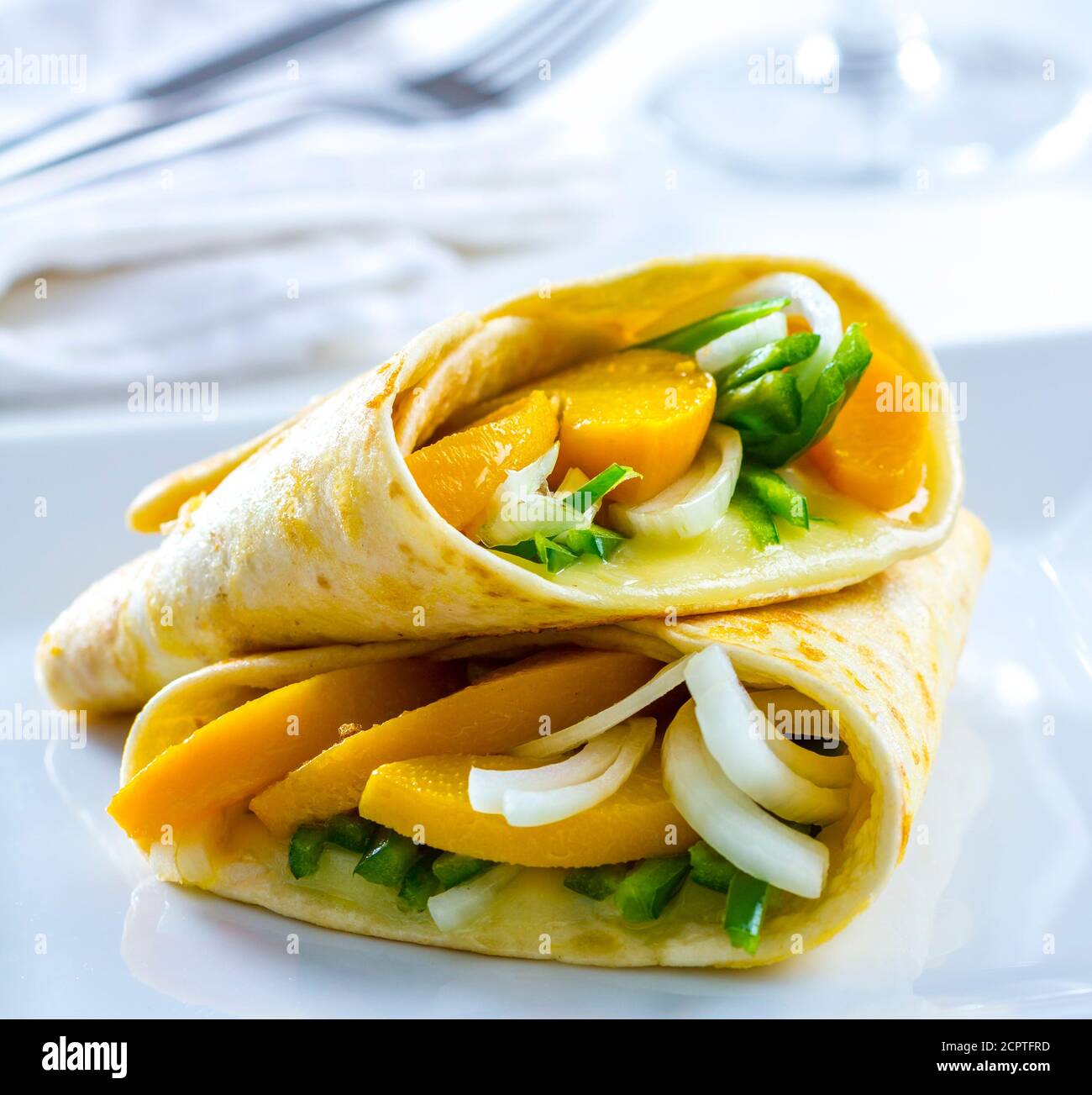 Delicious vegetarian wrap with fruit, vegetables and cheese. Stock Photo