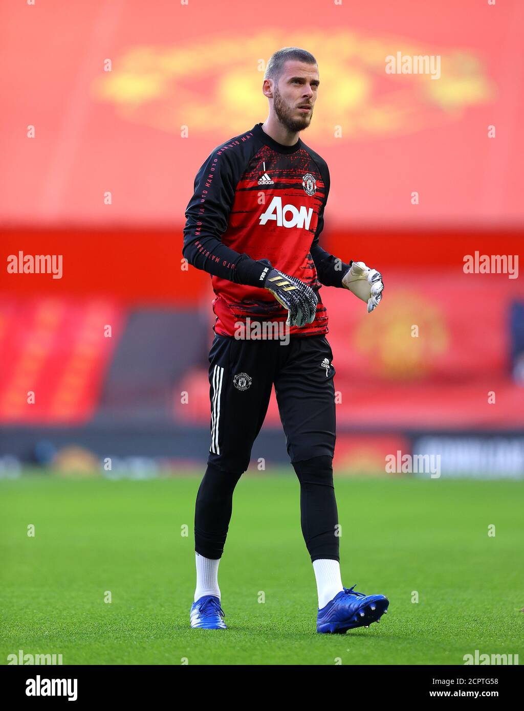 Manchester United goalkeeper David de Gea warming up before the Premier League match at Old Trafford, Manchester. Stock Photo