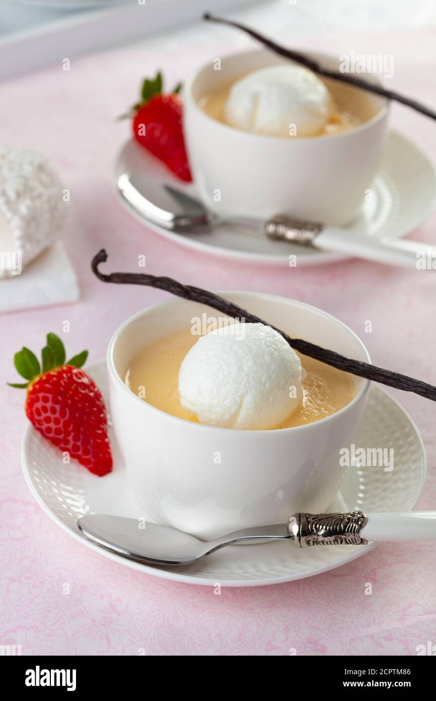 Floating island, in French ile flottante is a dessert of meringue floating on crème anglaise. The Hungarian variant is called madartej. Stock Photo