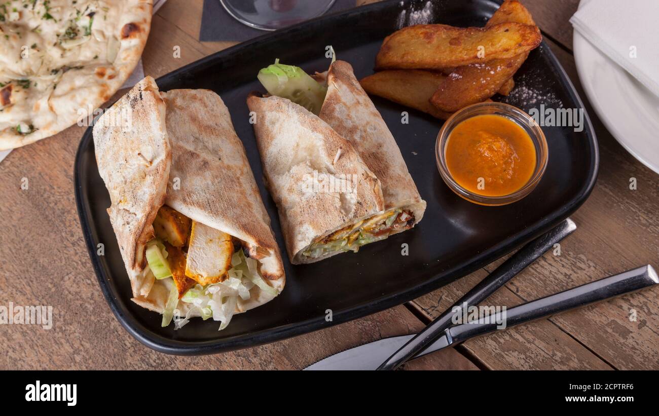 Indian food. Chicken tikka wrap sandwich Stock Photo Alamy