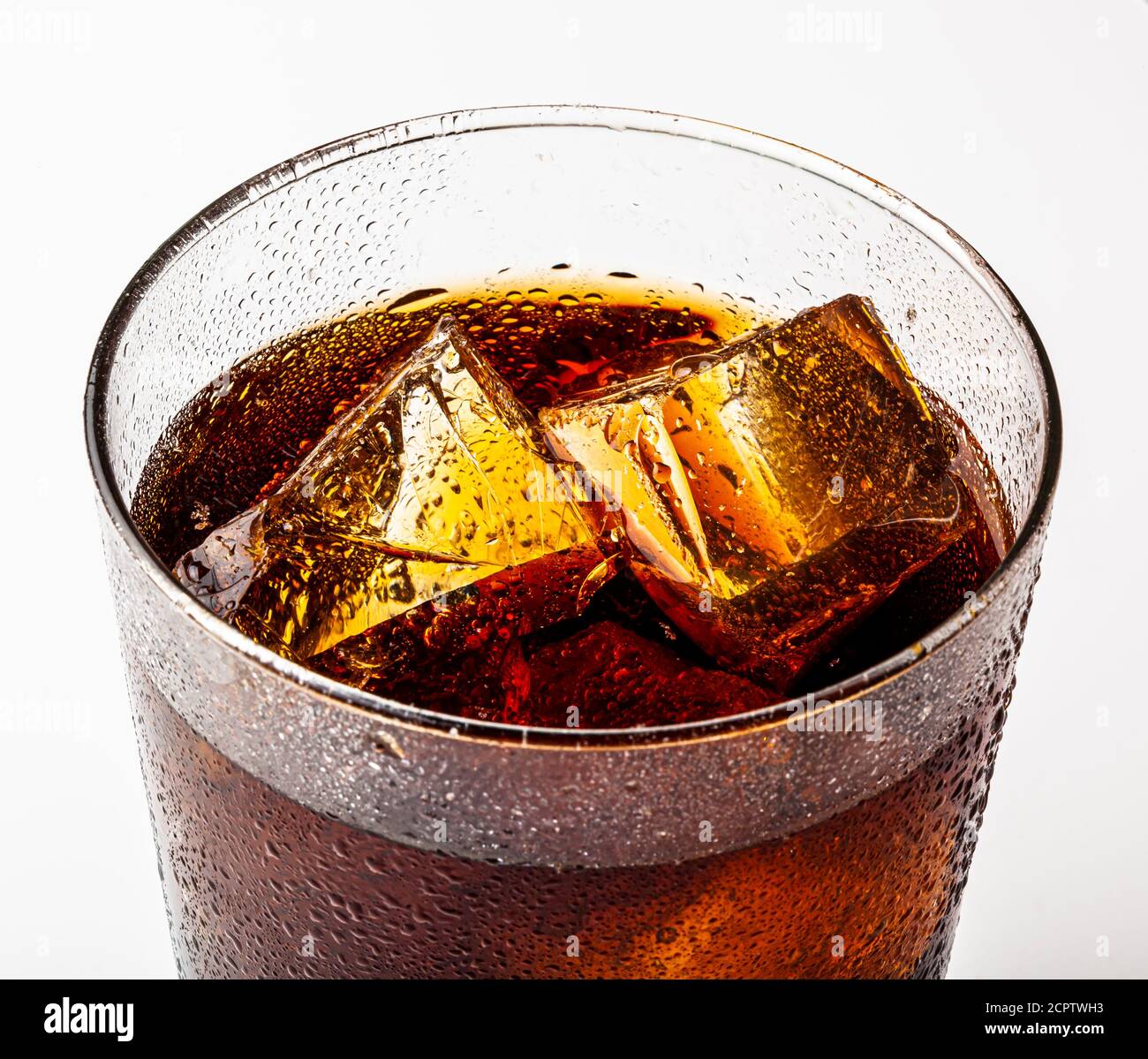 Ice cold refreshing carbonated summer drink with ice chunks in a glass. Stock Photo
