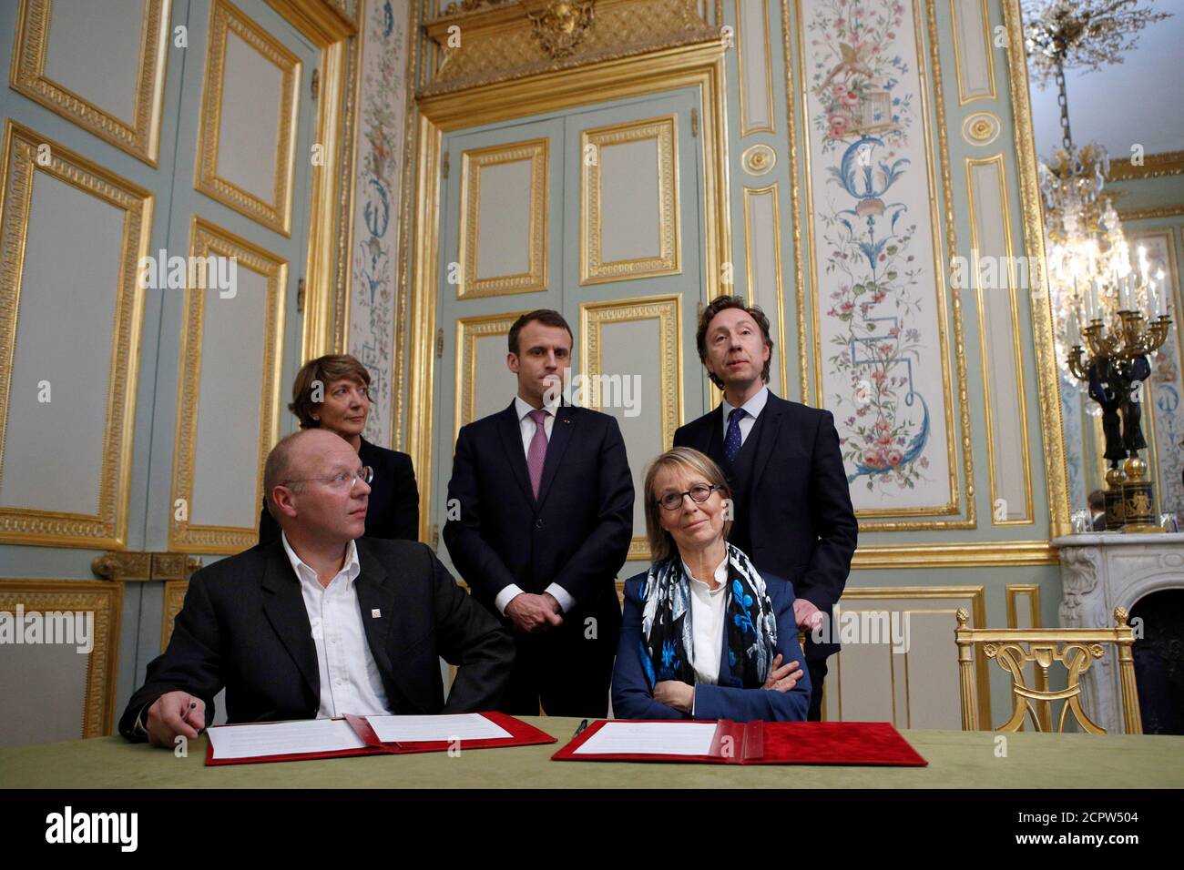 French Culture Minister Francoise Nyssen (R) and President of the Heritage Foundation Guillaume Poitrinal (L) pose withFrench President Emmanuel Macron (C) flanked with Stephan Pallez, President of the French Lottery 'Francaise des Jeux' (L) and French TV host Stephane Bern (R) during a cultural heritage agreement meeting at the Elysee Palace in Paris, France, February 13, 2018. REUTERS/Francois Mori/Pool Stock Photo