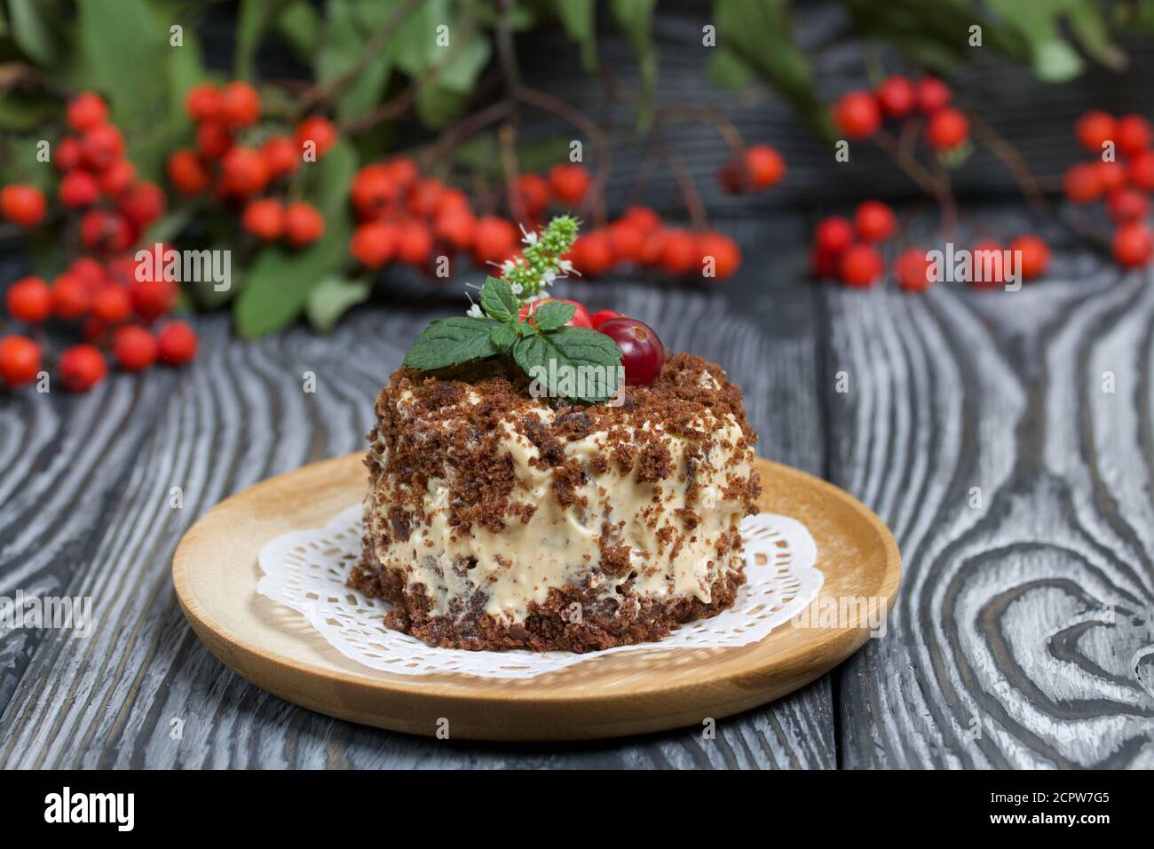 Sponge Cake With Butter Cream Decorated With Cranberries And Mint Nearby Are Rowan Branches With Berries Against The Background Of Brushed Pine Boa Stock Photo Alamy