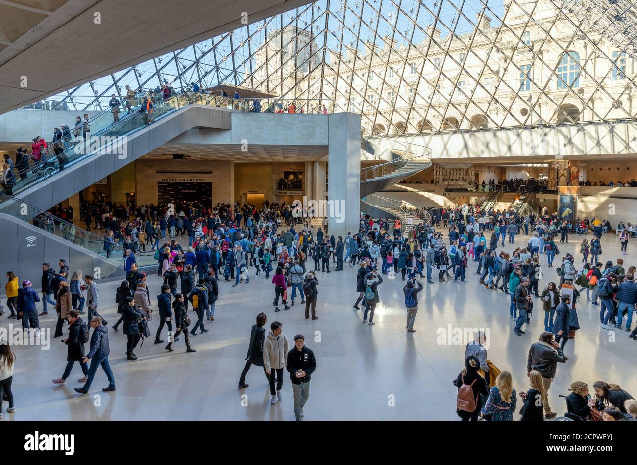 Tourists visit Louvre museum on December 30, 2019 in Paris. Louvre is the world's largest and most visited art museum in the world. Stock Photo