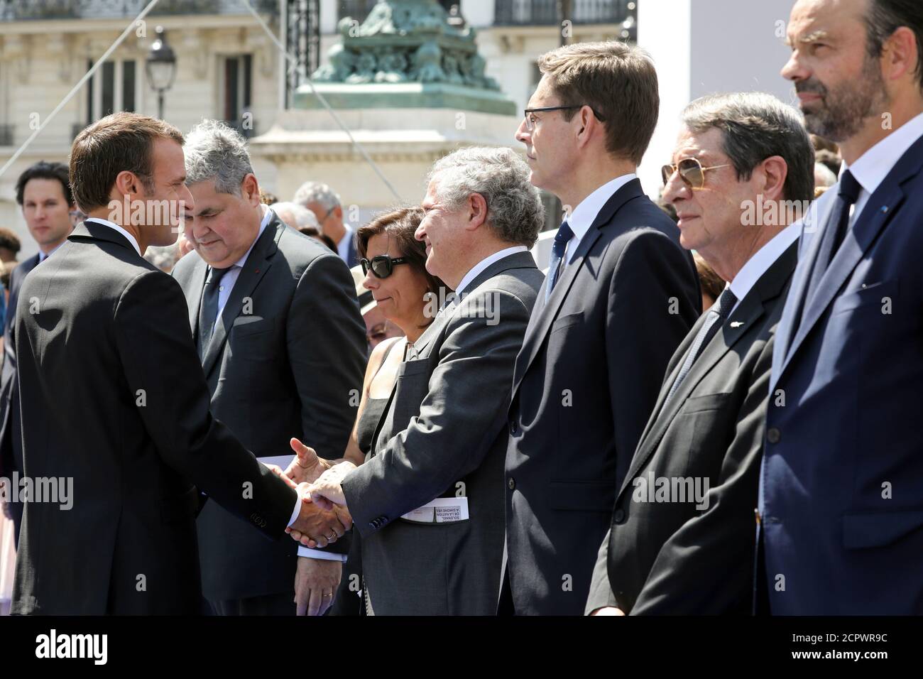 French President Emmanuel Macron speaks with Jean Veil and his wife  Dorothee Finot, who stands next to Pierre-Francois Veil (2ndL), sons of  late Auschwitz survivor and French health minister Simone Veil and