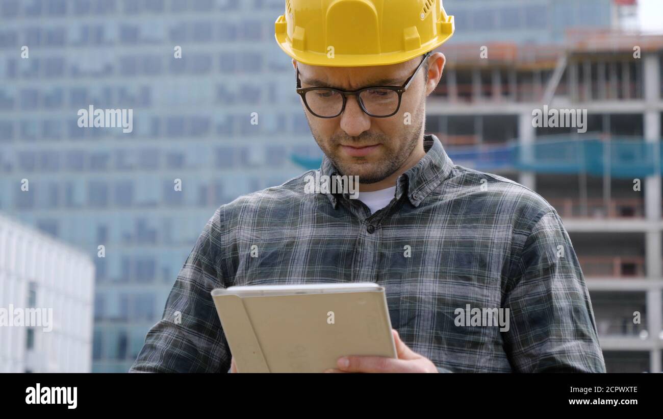 Engineer using digital tablet at construction site. Stock Photo