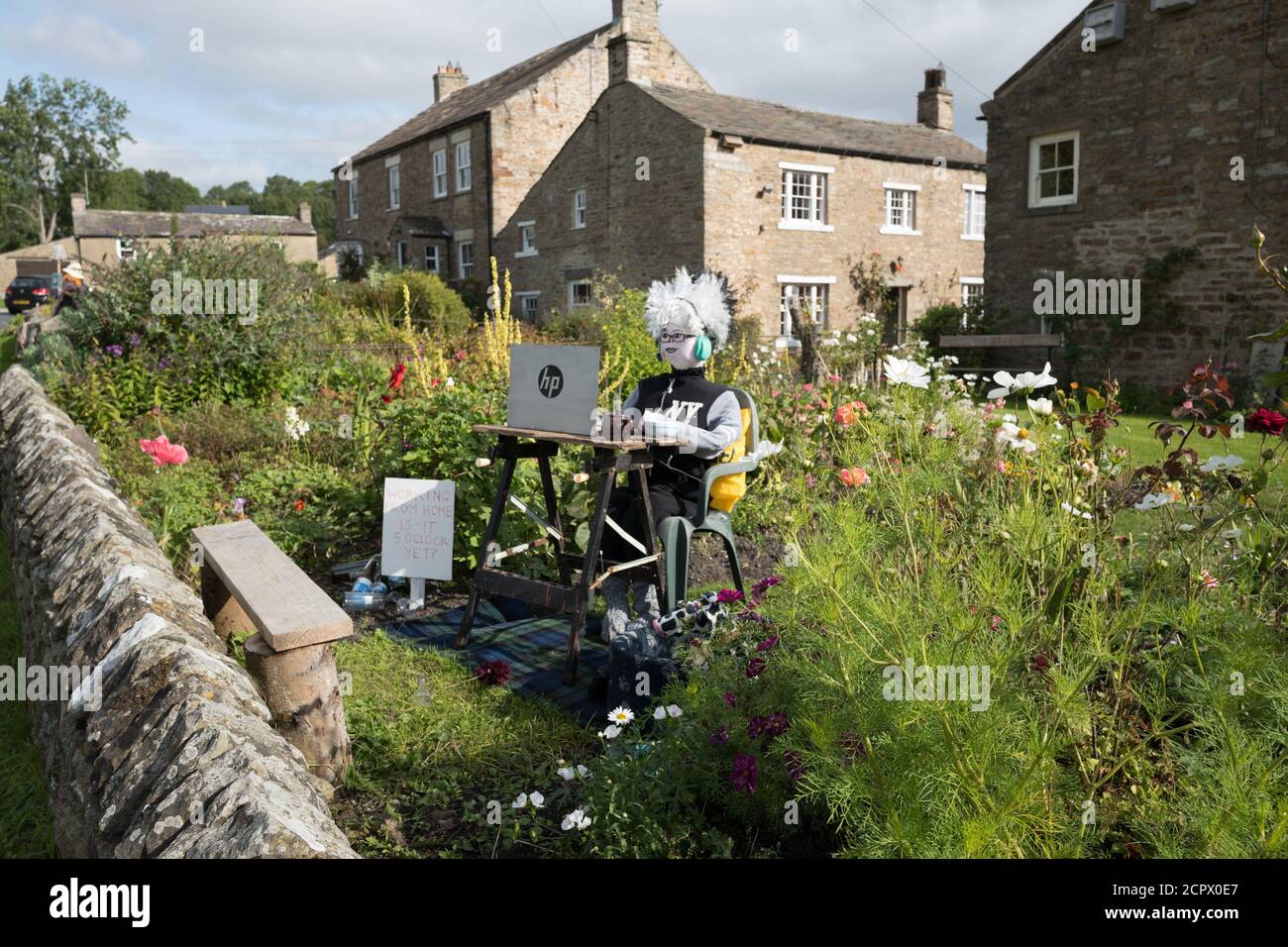 Redmire, Yorkshire Dales, England, UK. 19th Sep, 2020. This years theme for the Yorkshire Dales village of Redmire annual scarecrow competition being Covid 19 and the Lockdown. Due to the Covid 19 virus, virtual judging took place to select the winning scarecrow. The female scarecrow at the sowing machine making face masks was declared the winning. Credit: Alan Beastall/Alamy Live News. Stock Photo
