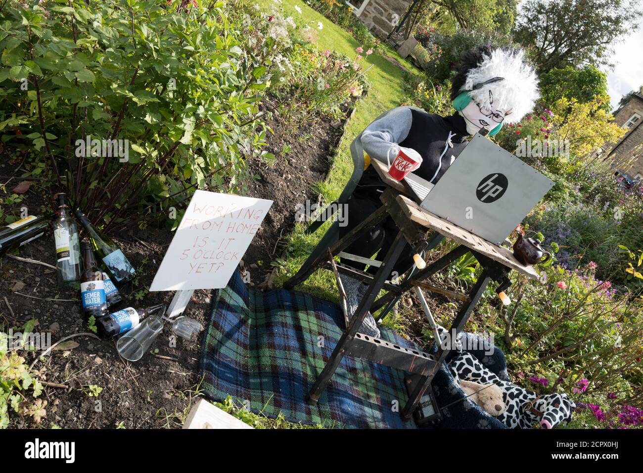 Redmire, Yorkshire Dales, England, UK. 19th Sep, 2020. This years theme for the Yorkshire Dales village of Redmire annual scarecrow competition being Covid 19 and the Lockdown. Due to the Covid 19 virus, virtual judging took place to select the winning scarecrow. The female scarecrow at the sowing machine making face masks was declared the winning. Credit: Alan Beastall/Alamy Live News. Stock Photo