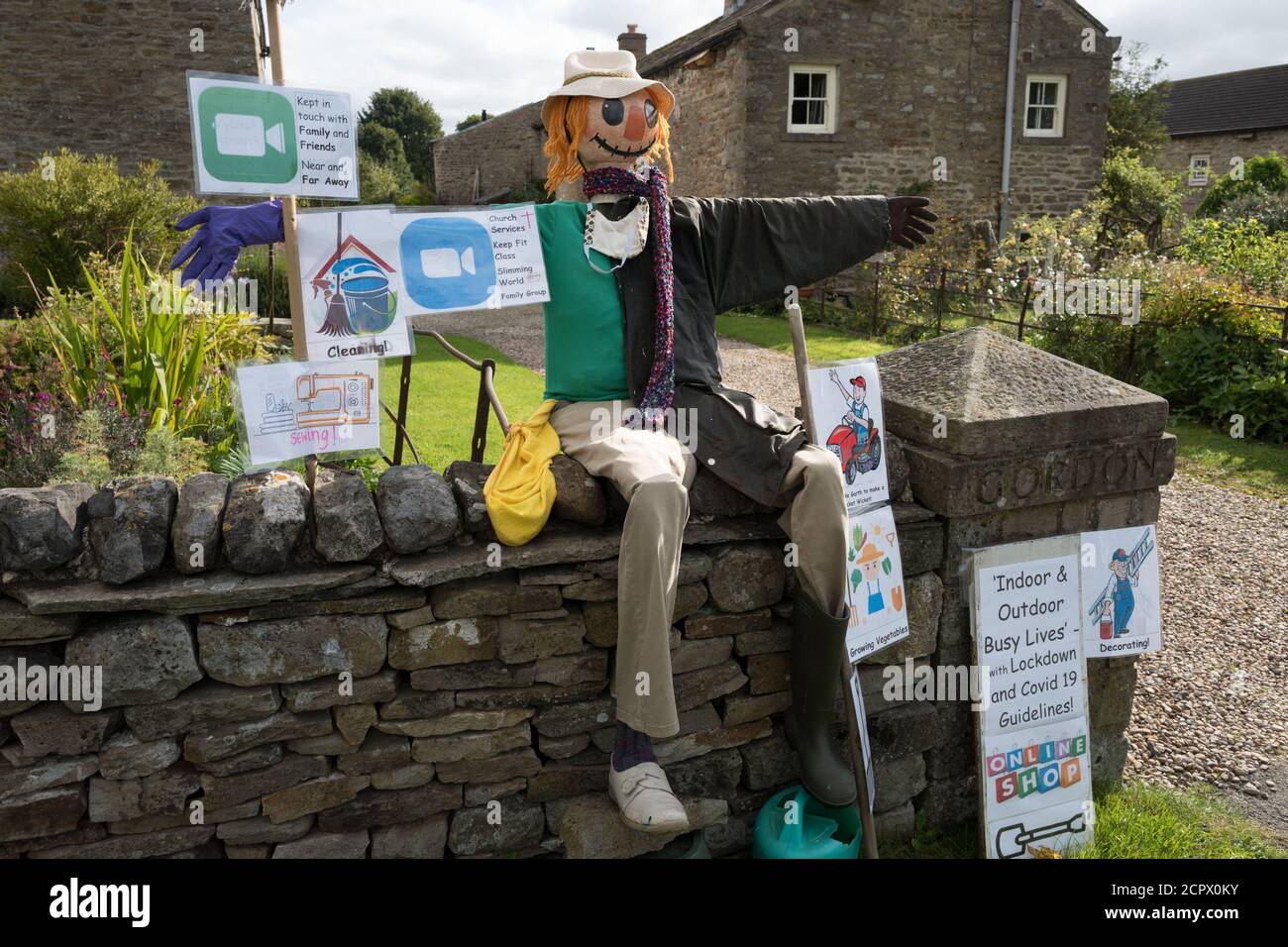 Redmire, Yorkshire Dales, England, UK. 19th Sep, 2020. This years theme for the Yorkshire Dales village of Redmire annual scarecrow competition being Covid 19 and the Lockdown. Due to the Covid 19 virus, virtual judging took place to select the winning scarecrow. The female scarecrow at the sowing machine making face masks was declared the winning. Credit: Alan Beastall/Alamy Live News. Stock Photo