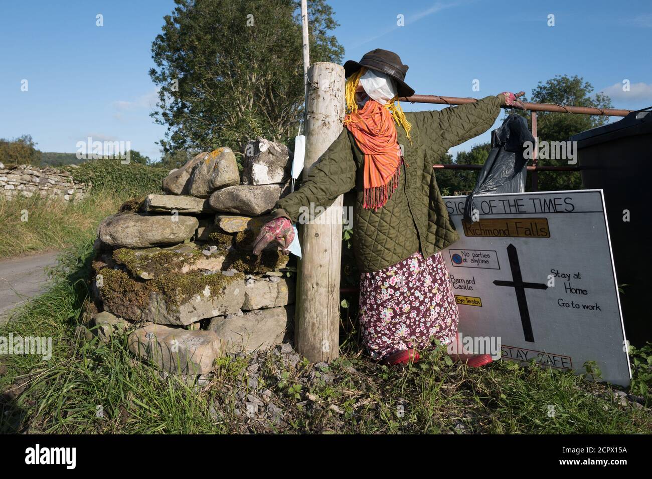 Redmire, Yorkshire Dales, England, UK. 19th Sep, 2020. This years theme for the Yorkshire Dales village of Redmire annual scarecrow competition being Covid 19 and the Lockdown. Due to the Covid 19 virus, virtual judging took place to select the winning scarecrow. The female scarecrow at the sowing machine making face masks was declared the winning. Credit: Alan Beastall/Alamy Live News. Stock Photo