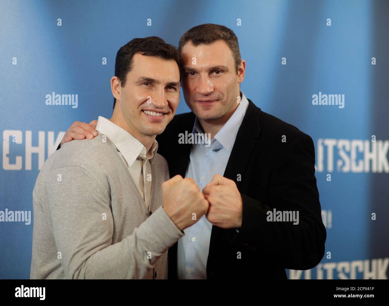 Ukrainian boxers Wladimir (L) and Vitali Klitschko pose for pictures as  they promote their movie 'Klitschko' in Berlin, April 7, 2011.  REUTERS/Thomas Peter (GERMANY - Tags: ENTERTAINMENT SPORT BOXING Stock  Photo - Alamy